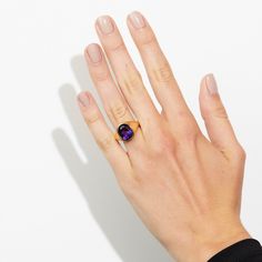 Take your style to a higher level with the magnificent Aphrodite statement ring featuring an oval amethyst made with Fairmined 18k yellow gold by Chroma. • Fairmined 14k yellow gold • 4.90ct Oval Amethyst • Band Width: 2mm - 6mm • In stock in size 6. This ring is able to be resized, please allow 4 weeks. Designed and crafted by us in NYC using recycled gold, conflict-free diamonds and responsibly sourced gemstones. The Fairmined program certifies gold created by small scale mining organizations, Luxury Oval Amethyst Ring With Polished Finish, Luxury Polished Oval Amethyst Ring, Luxury Yellow Gold Amethyst Ring Oval Cabochon, Timeless Yellow Gold Amethyst Ring With Oval Shape, Gold Amethyst Oval Cabochon Ring, Modern Gold Amethyst Gemstone Ring, Timeless Gold Oval Amethyst Ring, Oval Amethyst Ring In Luxury Style, Elegant Purple Amethyst Signet Ring