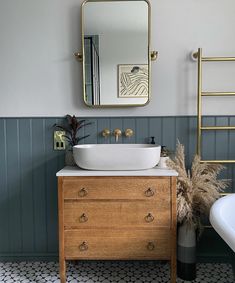 a bathroom with a sink, mirror and bathtub