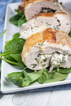 a white plate topped with meat and spinach