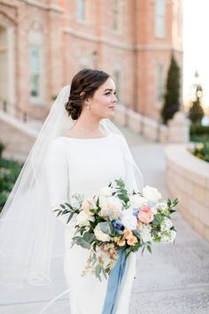 a woman in a wedding dress holding a bouquet