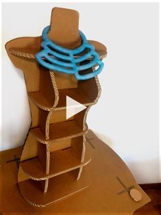 a cardboard mannequin with blue rings on it's top and bottom part