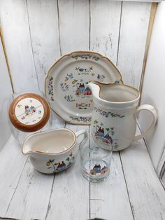 a white table topped with dishes and cups