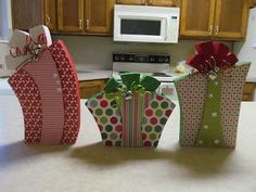 three gift bags sitting on top of a kitchen counter