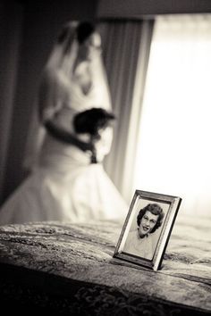 a black and white photo of a woman in a wedding dress next to a framed photograph