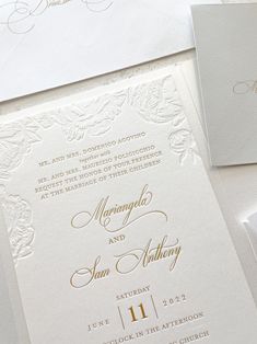 the wedding stationery is laid out on top of each other