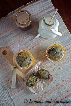 three blueberry muffins sitting on top of a table