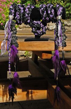 purple and black decorations are hanging from a table