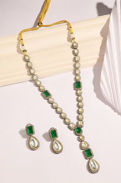 Elevate your saree ensemble with this beautiful necklace set, blending traditional and contemporary styles seamlessly. The polki encrusted necklace is adorned with stunning emerald green stones and cubic zirconia, adding a touch of elegance and glamour. Complete with a pair of matching earrings, this set is the perfect accessory to enhance your saree look, offering timeless beauty and sophistication. Finish: 22KT Gold Plating Material: Silver, Copper Alloy, Emeralds & CZs Color: Green Size: Free Sari Look, Hand Jewelry Rings, Chain Braid, Emerald Green Stone, Green Stones, Saree Look, Hand Jewelry, Anklet Jewelry, Beautiful Necklace