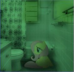 a little pony sitting on the floor in a bathroom