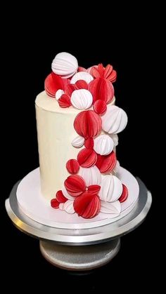 a white cake with red and white decorations