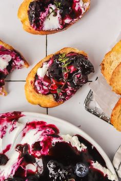 several pastries with blueberry sauce and whipped cream