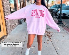 This preppy senior sweatshirt is the perfect gift for teenage girls in the Class of 2023! Featuring a crewneck style and a fun coconut girl aesthetic, this athletic school spirit shirt is sure to show off your Senior 2023 pride. ⭐️ * I T E M * I N F O* ✦ Gildan Unisex Sweatshirt ✦ This is made from a cozy, thinner material- perfect year round! ✦ Printed using Direct To Garment style- Inks are printed directly into the fabric. ✦ Different sizing may effect placement of final design. ✦ Colors may Trendy Pink Sweatshirt For College, Pink College Sweatshirt With Letter Print, Pink Letter Print Sweatshirt For College, Oversized School Spirit Sweatshirt For Campus, Pink Crew Neck Sweatshirt For College, Preppy Crew Neck Top For College, Fall School Sweatshirt, Pink Casual School Sweatshirt, Casual Pink Sweatshirt For School