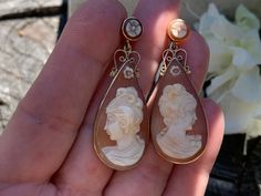 "These fabulous cameo earring are set in 14k yellow gold. They date from the 1960s. Possessing entrancing whimsy, this carved conch shell cameo is beautifully detailed. The profile of the lovely woman has an enchanted expression about her. The simplicity of the solid gold frame really highlights the beautiful carved conch cameo profile. The earring measures 2\" x 5/8\" wide at its widest point.They weigh 10.23 grams. They are made for pierced ears. EA 444 SIX MONTH LAYAWAY AVAILABLE" Carved Yellow Gold Earrings For Formal Occasions, Cameo Drop Earrings For Formal Occasions, Formal Carved Gold Earrings, Cameo Drop Earrings For Wedding, Formal Carved Yellow Gold Earrings, Formal Gold Carved Earrings, Vintage Intaglio Earrings For Wedding, Formal Carved Earrings, Victorian Cameo Earrings For Formal Occasions