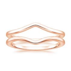 a rose gold wedding ring set with wavy lines on the side and an open band