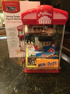 a red popcorn machine sitting on top of a counter