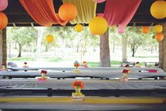 tables covered in yellow and red paper lanterns