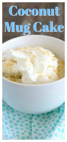 coconut mug cake with whipped cream in a white bowl on a blue and white tablecloth