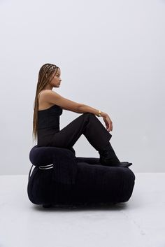 a woman sitting on top of a bean bag chair