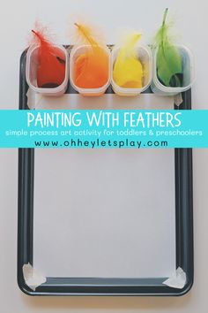 three different colored feathers sitting on top of a black tray with text overlay reading painting with feathers simple process art activity for toddlers & preschoolers