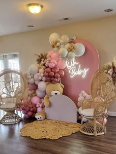 a room filled with balloons and teddy bears on the wall next to a pink heart shaped bed