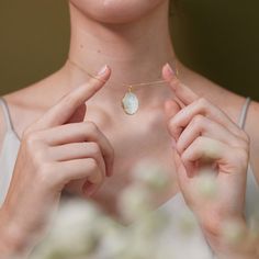 Our Oval Pearl Locket is more than just a stunning accessory--it's a symbol of purity, wisdom, and life's cherished moments. Pearls have long been associated with innocence, integrity, and grace, making this locket a perfect way to commemorate meaningful experiences. Just as a pearl transforms from a simple grain of sand into a luminous gem, our Oval Pearl Locket allows you to preserve the memories that shape your life. The pearl's soft, radiant glow reflects the wearer's inner beauty, while its Mother Of Pearl Necklace Locket, Pearl Locket, Engraved Locket, Nickel Free Jewelry, Oval Locket, Grain Of Sand, Gold Locket, Eco Friendly Jewelry, Photo Locket