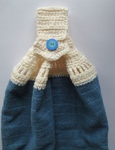 a crocheted blue bag with a button on it