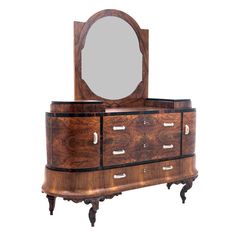 a wooden dresser with mirror on top of it's drawers and two small legs