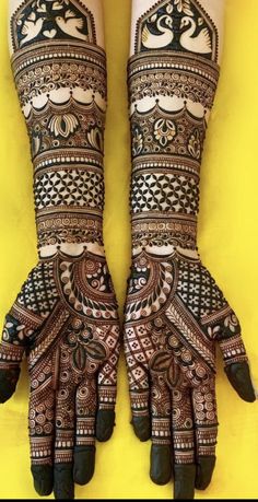 two hands with henna designs on them