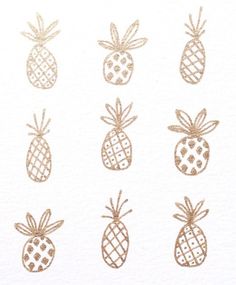 the pineapples are drawn in gold ink on white paper, and each has different designs