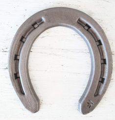 a horseshoe shaped object sitting on top of a white table