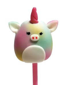 a close up of a candy on a stick with a pig face painted on it