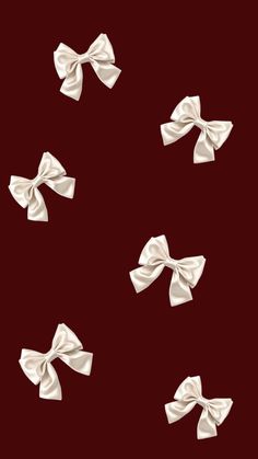 four white bows on a red background