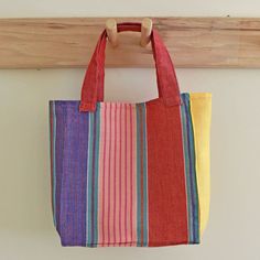 Child sized tote bag is ready to fill with things for the beach, the drive to the zoo, or the farmer's market with mom. Handwoven 100% cotton in bright multicolor stripes in red, pink, yellow and blue. 9" High x 7.5" Wide x 3.5" deep with 2 straps that have a 5.5" drop. Washable and dryable! Summer Multicolor Cotton Canvas Bag, Multicolor Cotton Canvas Summer Bag, Vibrant Multicolor Bags For Summer, Vibrant Multicolor Summer Bags, Rectangular Multicolor Beach Bag For Everyday Use, Multicolor Bucket Beach Bag For Everyday, Everyday Multicolor Bucket Beach Bag, Multicolor Cotton Summer Bag, Multicolor Canvas Shopping Bag