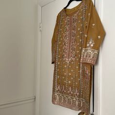 Worn Only Once In Excellent Condition This Suit Comes With A Fully Embroidered Kameez Which Is Organza Based Shalwar Also Has Some Embroidery On The Bottom The Dupatta Is Also Organza Based And Has A Beautiful 2 Side Pallu And 2 Side Small Boarder Indian Pakistani Yellow Chinon Traditional Wear With Intricate Embroidery, Yellow Salwar Kameez With Intricate Embroidery, Festive Yellow Straight Kurta Lawn Suit, Yellow Chinon Dupatta With Intricate Embroidery, Festive Yellow Lawn Suit With Straight Kurta, Yellow Lawn Suit With Zari Work Straight Kurta, Yellow Anarkali Kurta With Intricate Embroidery, Yellow Dabka Kurta For Eid, Festive Yellow Kurta With Intricate Embroidery