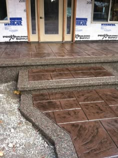 the steps are made out of concrete and have brown tiles on them with white trim