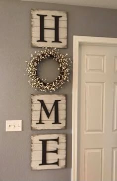 the wall is decorated with three wooden letters and a wreath