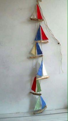 a group of sailboats hanging on a wall