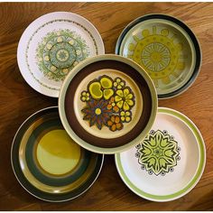 several plates with designs on them sitting on a table