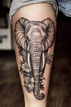 Elephant tattoo with flowers on a person's leg. Elephant Tattoo On Forearm, Ornamental Elephant Tattoo, Elephant Tattoos Men Forearm, Trunk Up Elephant Tattoo, Elephant Tattoo Thigh, Elephant Face Tattoo, Elephant Tattoo Stencil, Tattoo Ideas Elephant