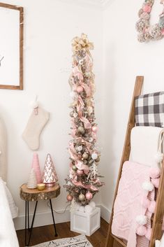 a pink christmas tree in the corner of a room