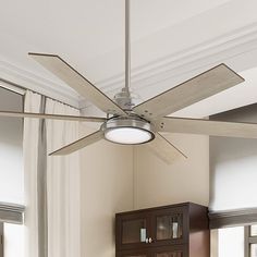 a ceiling fan in a room with white walls