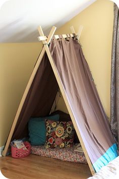 a teepee tent sitting on top of a wooden floor