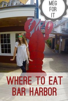 a woman standing next to a giant lobster sign with the words where to eat bar harbor