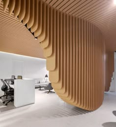 two photographs of an office with wooden slats on the ceiling and desks in the background