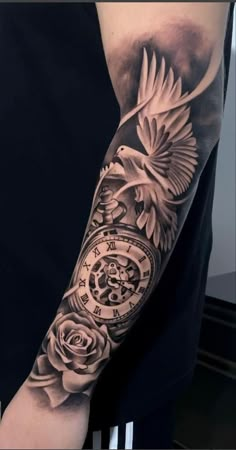 a man with a clock and roses tattoo on his arm