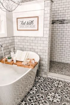 a white bath tub sitting in a bathroom next to a shower head mounted on the wall