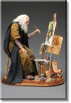 an old man sitting in front of a painting easel