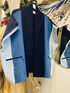 a blue and white jacket hanging on a wall