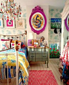 a bed room with a neatly made bed next to a dresser and paintings on the wall