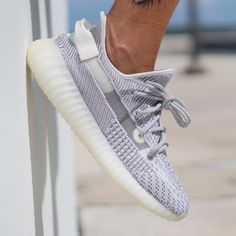 The adidas Yeezy Boost 350 v2 Static Reflective is a more limited edition of the colorway released in winter 2018. At first, this version appears identical to the standard Static colorway by Kanye West and adidas, featuring an intricate white and grey pattern across the upper with transparent thread for the side stripes. But hit it with light, and youll see that it also incorporates reflective material within the Primeknit. Yeezy Shoes Women, Yeezy 350 Boost, Cutest Shoes